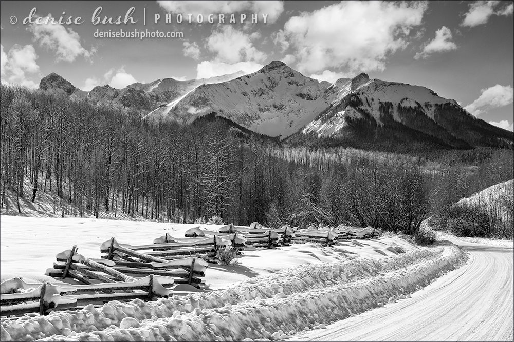 A road and rustic fence leads us toward Hayden Mountain of Colorado's San Juans. The road is closed up ahead in the winter.