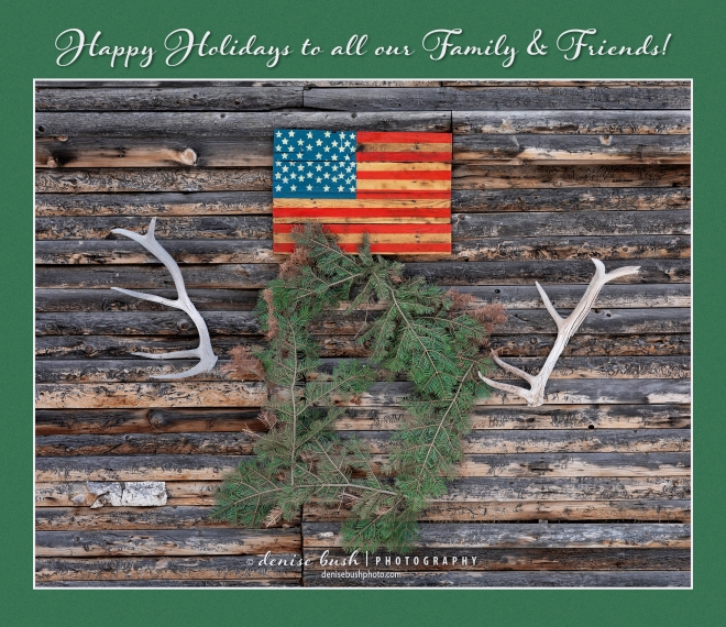 A wreath, flag and antlers created a charming greeting on the side of an old weathered barn.